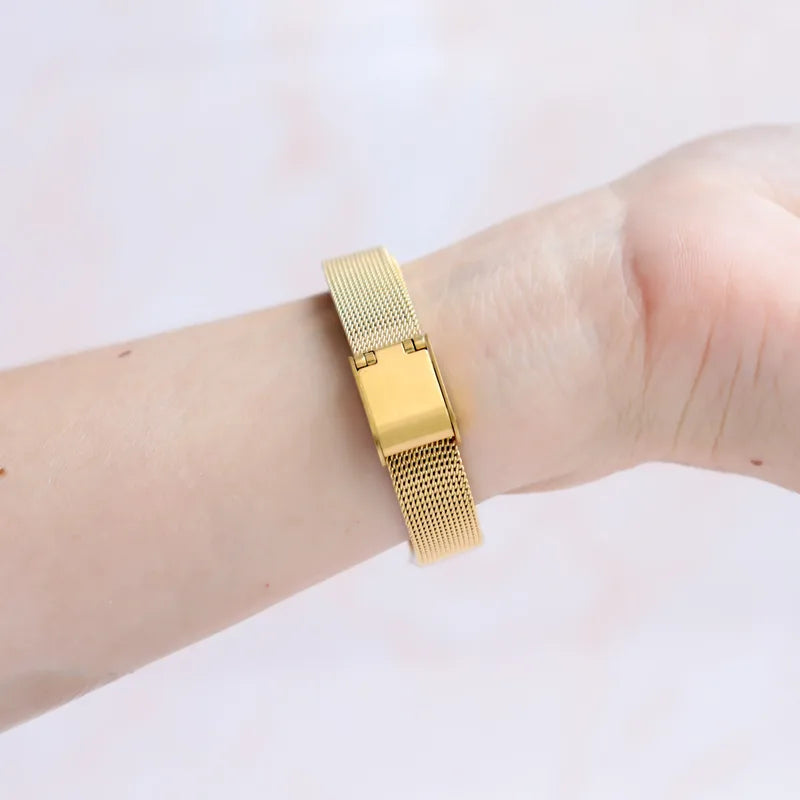 Gold mesh medical ID bracelet on a wrist